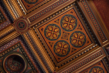 part of the decor and the material from which it is made;
symmetrical decorative patterns on a wooden plinth
