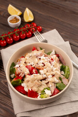 Mix of lettuce leaves with smoked chicken meat, tomatoes and salted soft cheese, with mustard-lemon dressing