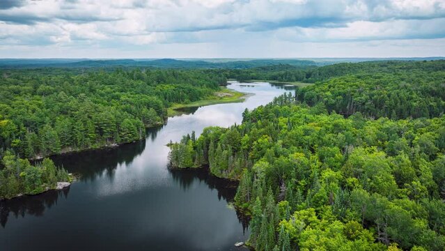 Forward motion hyper lapse with clouds over a river and forest in summer