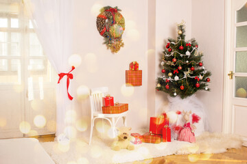 New Year's gifts under the Christmas tree in a beautifully decorated room interior.