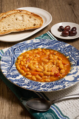 Homemade bean soup with vegetables . Greek bean soup with tomatoes, carrots, celery, and onions. Fasolada