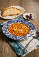 Homemade bean soup with vegetables . Greek bean soup with tomatoes, carrots, celery, and onions. Fasolada