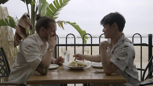 Gay couple chatting at dinner