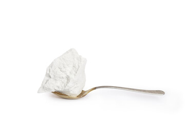 Natural food chalk of mountain origin peeled in a tablespoon on a white background