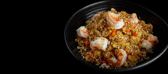 Fried rice with shrimp and sesame, on a dark background. Banner