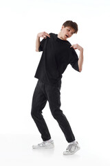 young man in black t-shirt and jeans dancing