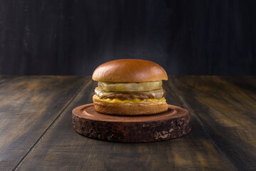 Pork burger topped with gratin mozzarella cheese, grilled pineapple and yellow mustard on a delicious brioche bun.