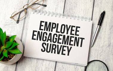 Employee Engagement Survey- written on paper notebook and office supplies