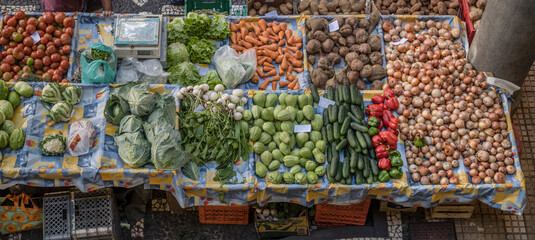 heaps of colorful  vegetables on sale on stall at covered market, Funchal, Madeira