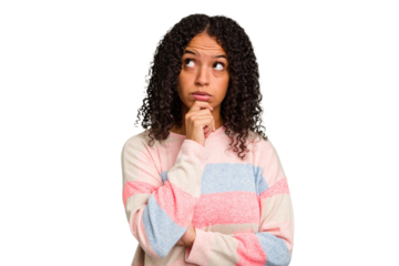 Young Brazilian curly hair cute woman isolated looking sideways with doubtful and skeptical expression.