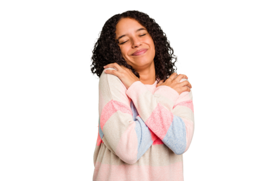 Young Brazilian curly hair cute woman isolated hugs, smiling carefree and happy.
