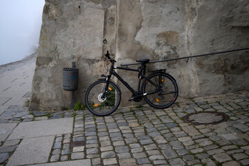 Fototapeta na wymiar Bike leaning against old stone wall in Passau germany