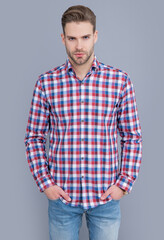 Fototapeta premium handsome man in checkered shirt isolated on grey background. man in casual style