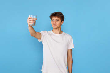 Young handsome man with drinking glass of water