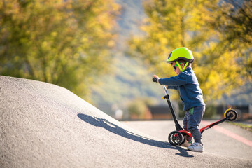 Kid riding kick scooter