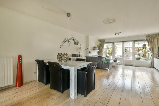 Spacious living room with comfy sofa and dining zone at modern villa