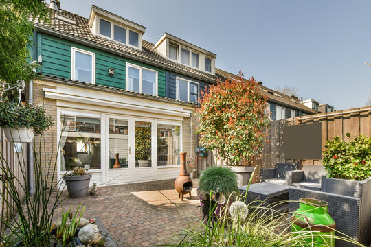 Residential house against patio with plants and sofa