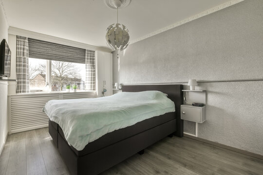 Soft bed and nightstand in modern light bedroom