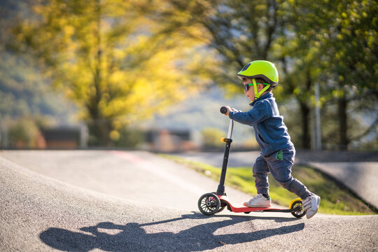 Kid riding kick scooter
