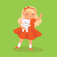 Girl in a dress holding a kitten in her hand