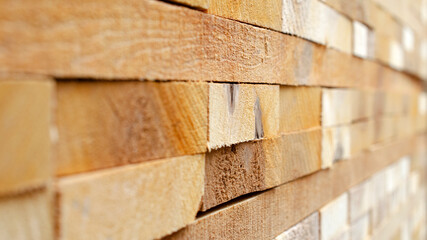 Industrial lumber, texture, wood background, close-up. Wood texture with rectangular patterns, background. Pine lumber, close-up, side view. Timber background, texture.