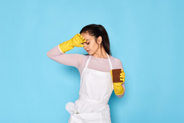 tired woman gloves and cleaner apron with sponge