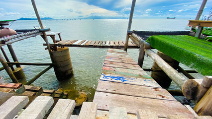 Fototapeta premium wooden bridge by the sea in the morning