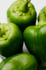 Green bell peppers close-up with water droplets. Home semi-hydroponic garden.