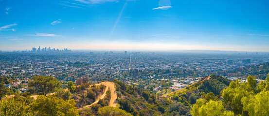 Los Angeles city skyline and natural woodland trails landscape from Griffith Observatory,...