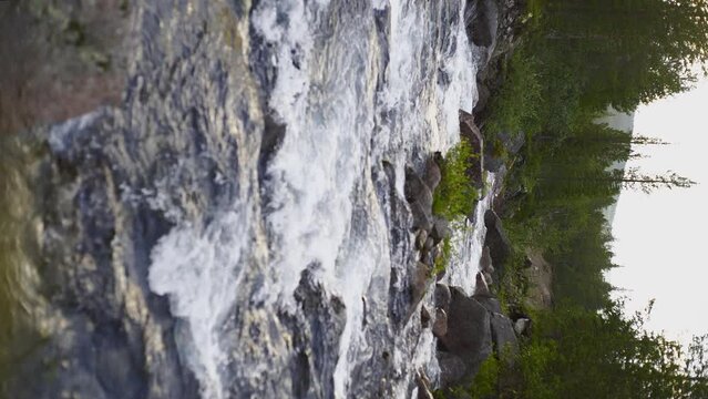 Vertical Screen: The swift and indomitable flow of a mountain river.