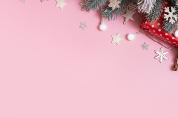 Pine trees branches with Cristmas New Year decoration top view, flat lay on pink background. Blank...