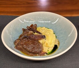 Plate with grilled meat sauce and mashed potatoes.