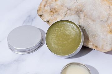 colorful lip balms in round tin cases , mockup design