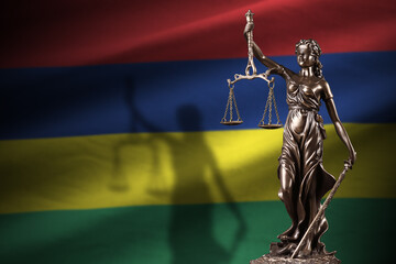 Mauritius flag with statue of lady justice and judicial scales in dark room. Concept of judgement...