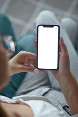 Mock up white screen blank close up mobile phone in woman hands holding Back view