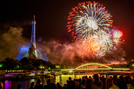 Fireworks over the Seine in Paris, France on Bastille Day. - Powered by Adobe