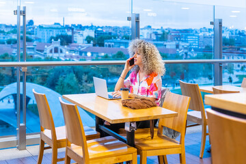 young caucasian woman with curly blonde hair teleworking