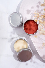 colorful lip balms in round tin cases with shadow overlay, mockup design