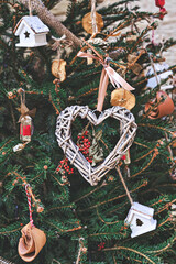 Christmas tree decorated with heart-shaped woven wreath and other handmade Christmas zero-waste ornaments. Zero-waste Christmas decoration