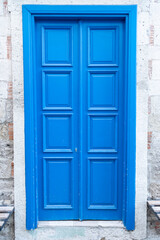 Charming House with wooden old blue door.