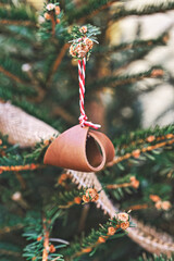 Closeup leather toy on Christmas tree branch. handmade Christmas zero-waste ornaments.