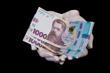 two hands with hryvnias. Closeup female hand giving money for something with isolated on black background,count, paying, shopping with hryvnias, corruption, counting hryvnias banknotes Ukraine