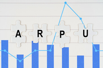 On business reports - diagrams are puzzles with the inscription - ARPU - obrazy, fototapety, plakaty
