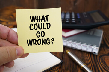 In the hands of a man is a sticker with the inscription - what could go wrong