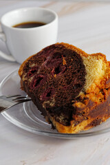 Close up view of piece of homemade marble cake with cherries