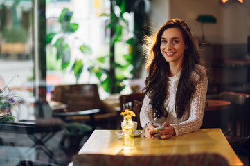 Portrait of beautiful young woman posing in a cafe