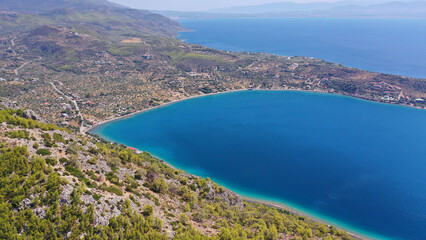Fototapeta na wymiar Aerial drone photo of scenic lake Vouliagmeni in Corinthia near famous lighthouse of Heraion and city of Loutraki featuring crystal clear turquoise beach and calm waters, Perachora, Greece
