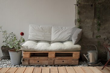 Pallet couch on terrace. Outdoor relax place with cozy pillow on wooden couch.