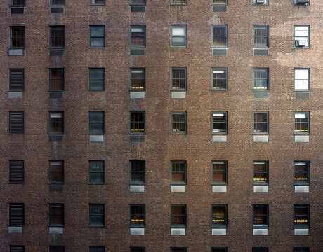 Facade of a brick-clad building and regular windows pattern, New York, USA
