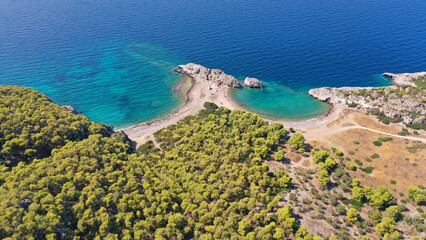 Fototapeta premium Aerial drone top down photo of scenic half moon shaped crystal clear sea beach of Milokopi near famous lake Vouiagmeni, Loutraki, Perachora, Greece